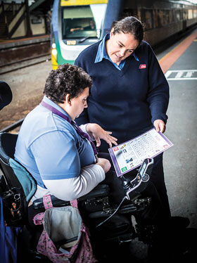 Image of transport officer assisting a person with a disability