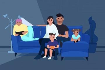 Family on a couch watching television