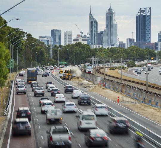 Multiple vehicles driving along the Mitchell Freeway, Western Australia.