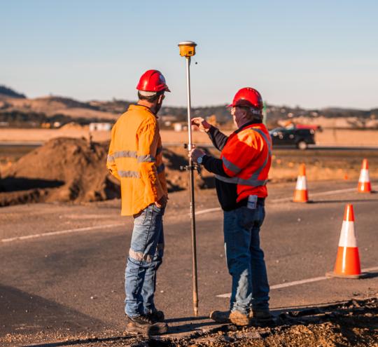 Two people doing survey work 