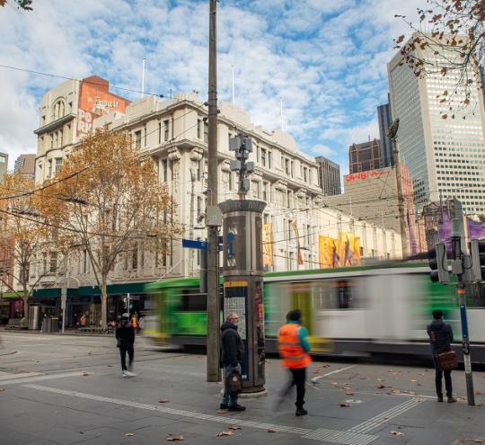 tram passing pedestrians