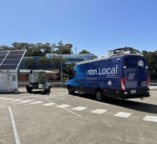 New NBN Co Powercube next to a blue NBN Co RoadMuster truck. Image supplied by NBN Co.