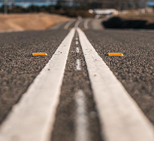 Improved road surface with double white centre lines.