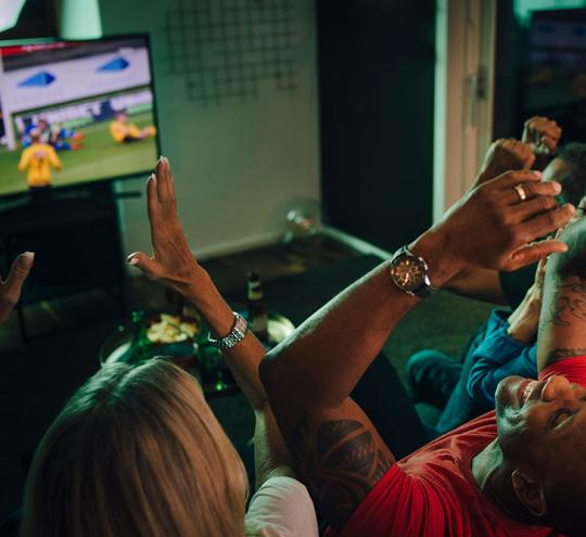 group watching sport on TV