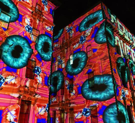 An art installation projected onto building facades in Melbourne.