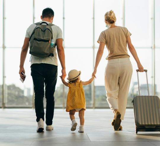 Family walking through an airport