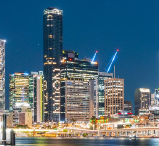 Image of the Brisbane City Skyline at night with 2032 Olympic Games lights on one of the buildings