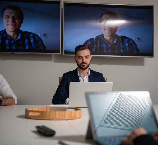 Business meeting on laptops.