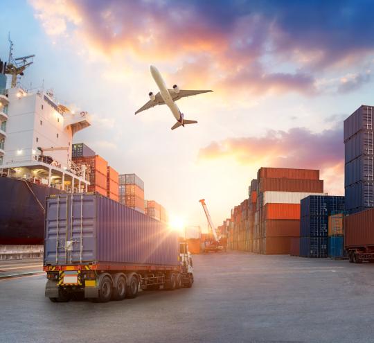 An image showing how freight can be transported over different modes, including road, rail, air, and sea. There are big cargo containers featured prominently.
