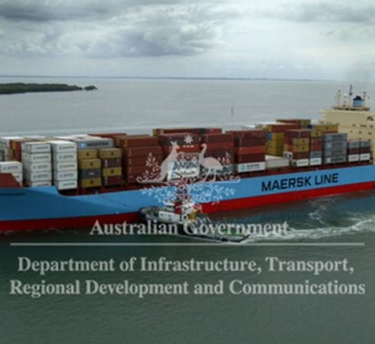 Image depicts a cargo ship entering Brisbane Port. Departrmental logo over the top: Australian Government, Department of Infrastructure, Transport, Regional Development and Communications.