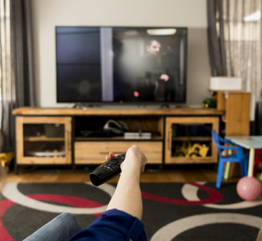 a family sitting on a couch watching TV