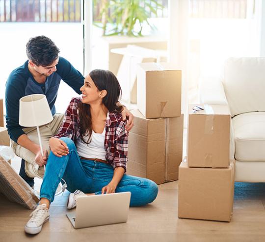 Couple unpacking boxes in a new home. Just moved in.