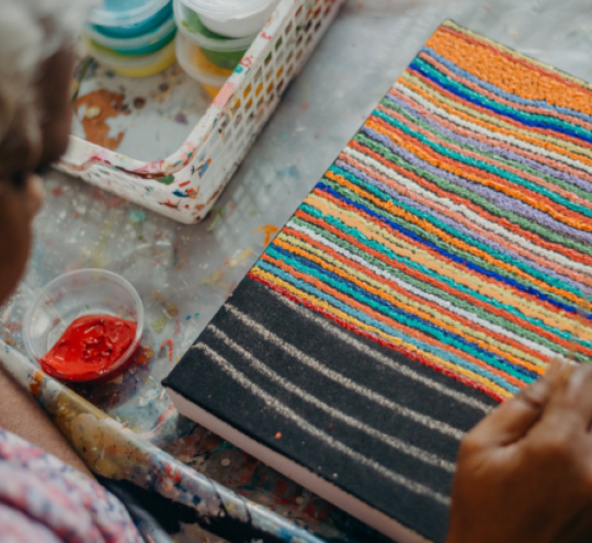 First Nations woman creating Indigenous art