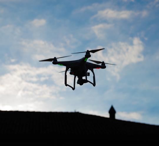drone flying over roof