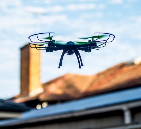 drone flying in front of house