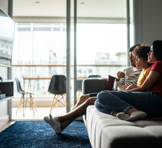 Family watching tv on the couch
