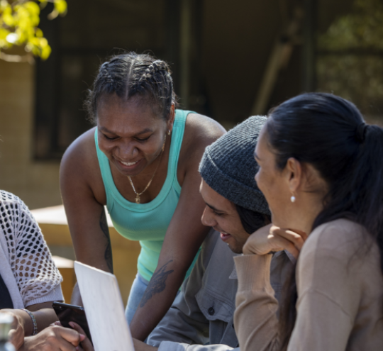 group of people looking at a mobile screen