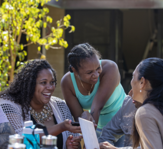 A group of young First Nations students sitting outdoors with a tutor.  Tutoring Together High-Res Stock Photo—Getty Images