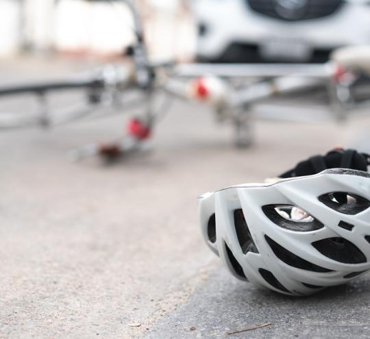 overturned bicycle and helmet on road