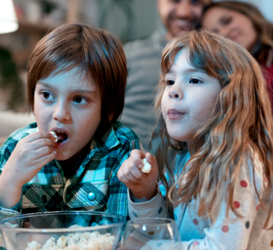 Family watching TV together at home