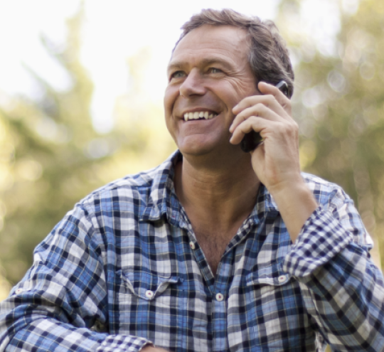 man speaking on phone outdoors