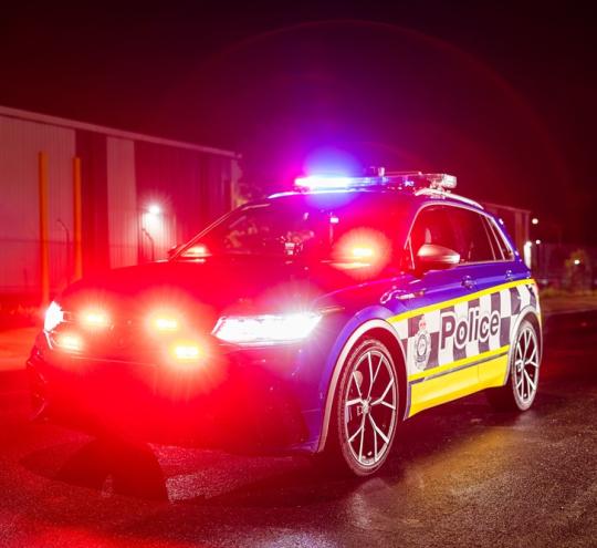 Police car driving at night