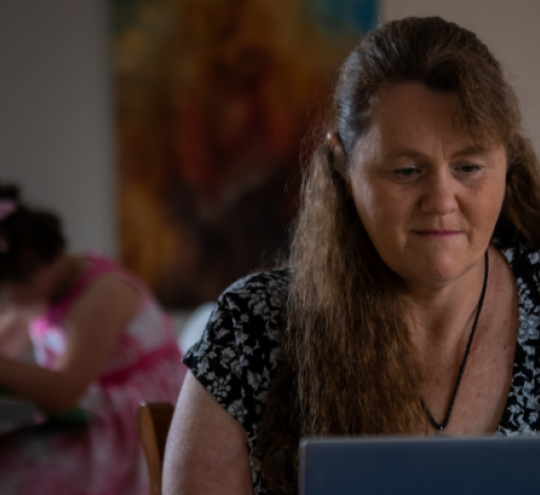 Woman at home using laptop.
