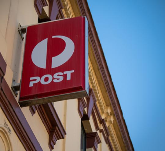 Australia Post sign on the side of a heritage building.