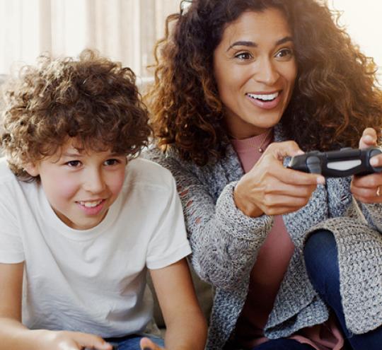Woman and child having fun playing a video game