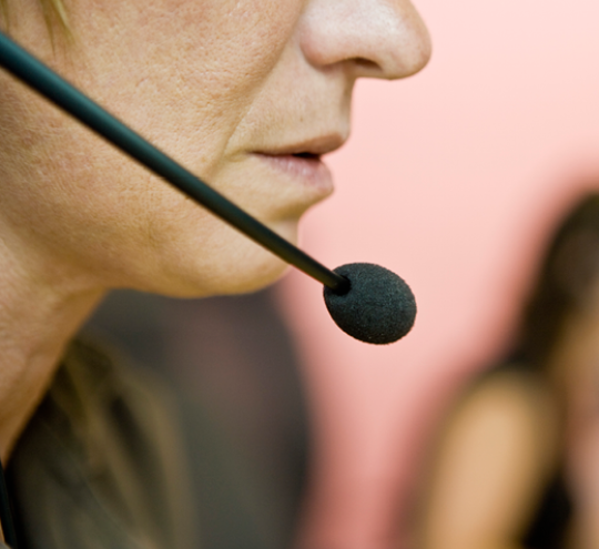 Person in a call centre with microphone