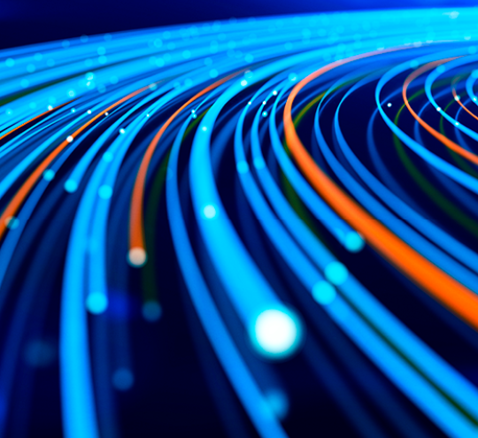 Close up of network data flowing on a dark blue background.