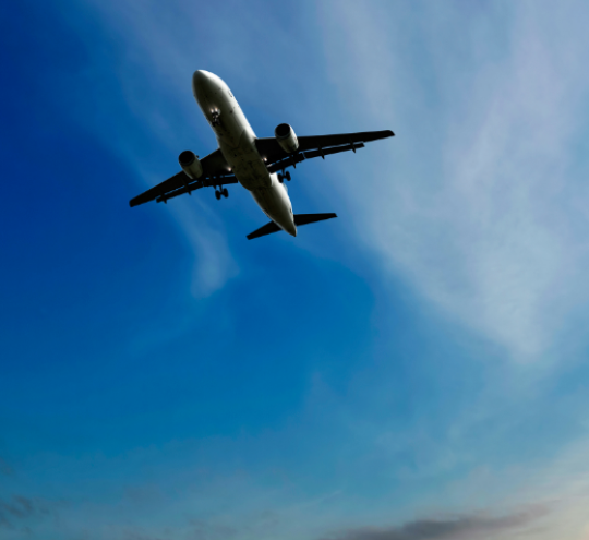 Plane flying up against a blue sky 