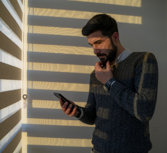 Man looking at mobile phone worried.