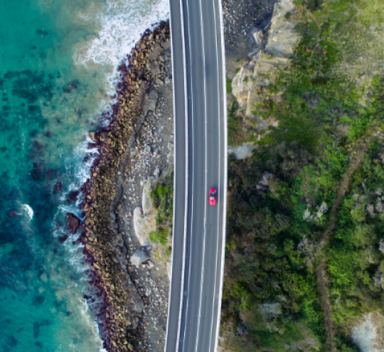 Aerial photograph of a car driving on the Sea Cliff Bridge, New South Wales