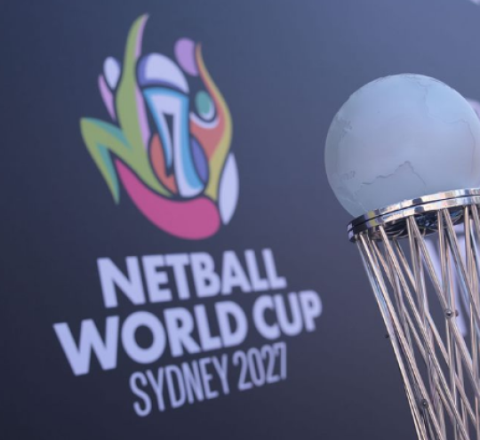 The Netball World Cup trophy sitting in front of a branded Netball World Cup Sydney 2027 backdrop.