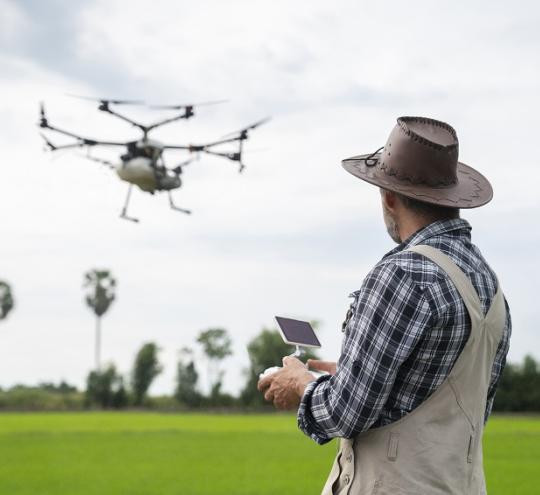 man controlling drone in flight