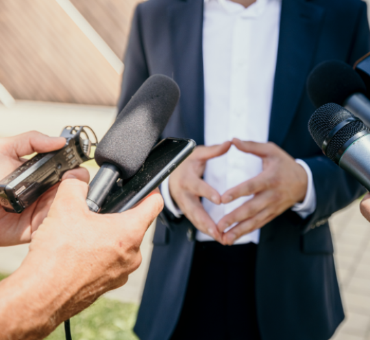 Person being interviewed by journalists 