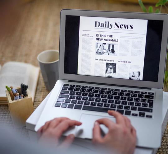 reading news on a laptop