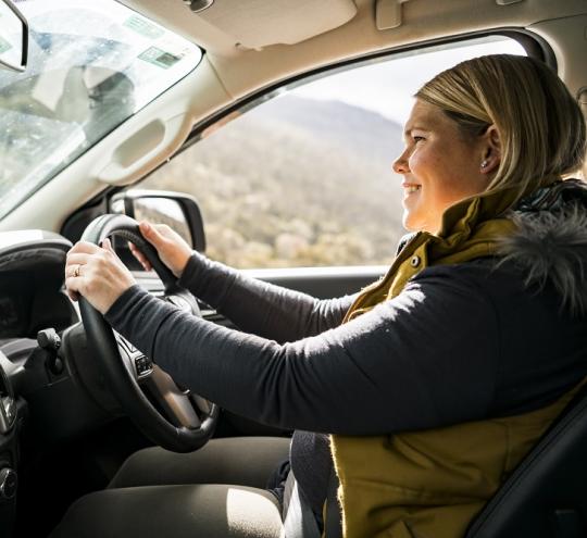 Person in the driver’s seat of a car driving.