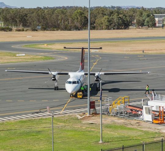Image of regional Australian airport with turboprop plane on tarmac 