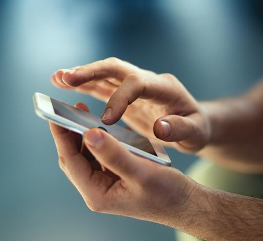 hands interacting with a mobile phone