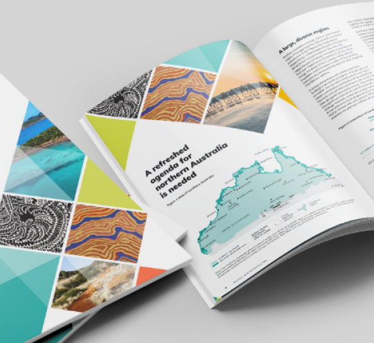 Multiple printed copies of the Northern Australia Action Plan laid out flat with images from northern Australia on the cover including First Nations artworks.