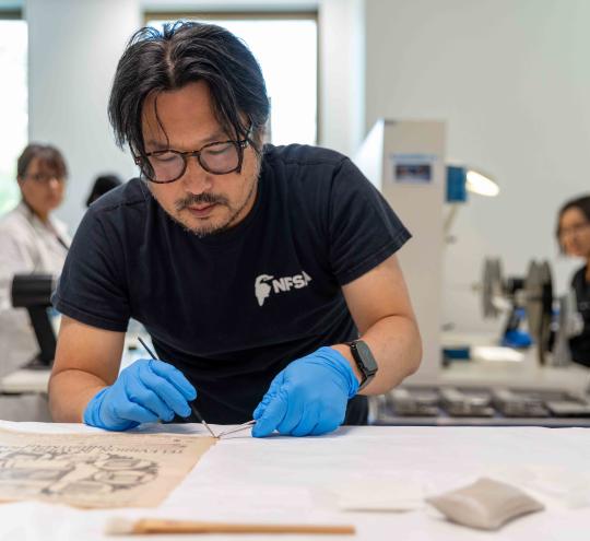 Team of archivists preserving documents.