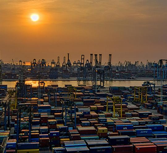 Port with shipping containers and cranes.