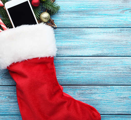 christmas stocking with mobile phone poking out the top