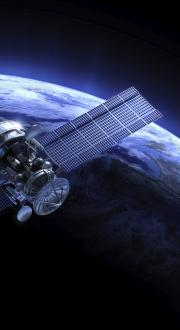 Satellite in space circling earth.