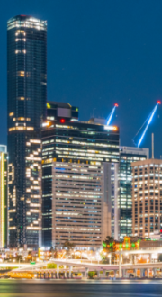 Skyline of Brisbane city buildings with Brisbane 2032 lit up in office lights on the tallest building