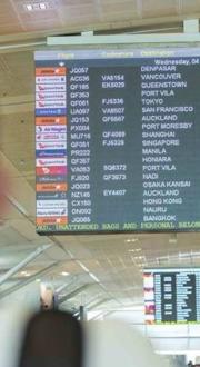 Passenger observing an airport departure board.