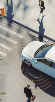 Electric vehicle at a pedestrian crossing.