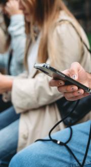image of four people looking at their smart phones
